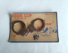 circa 1954 NOS vintage handcuffs still on orginal display cardboard police picture