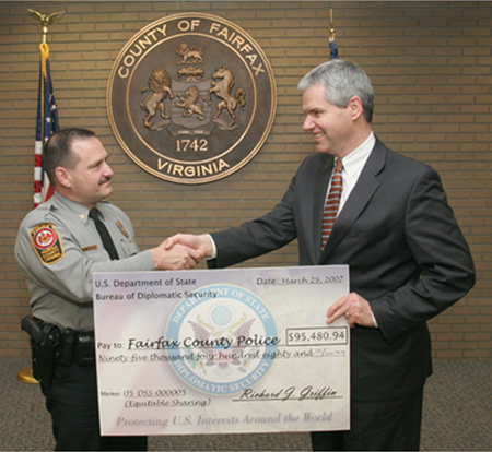 Former FCPD Chief David Rohrer receives an equitable sharing check